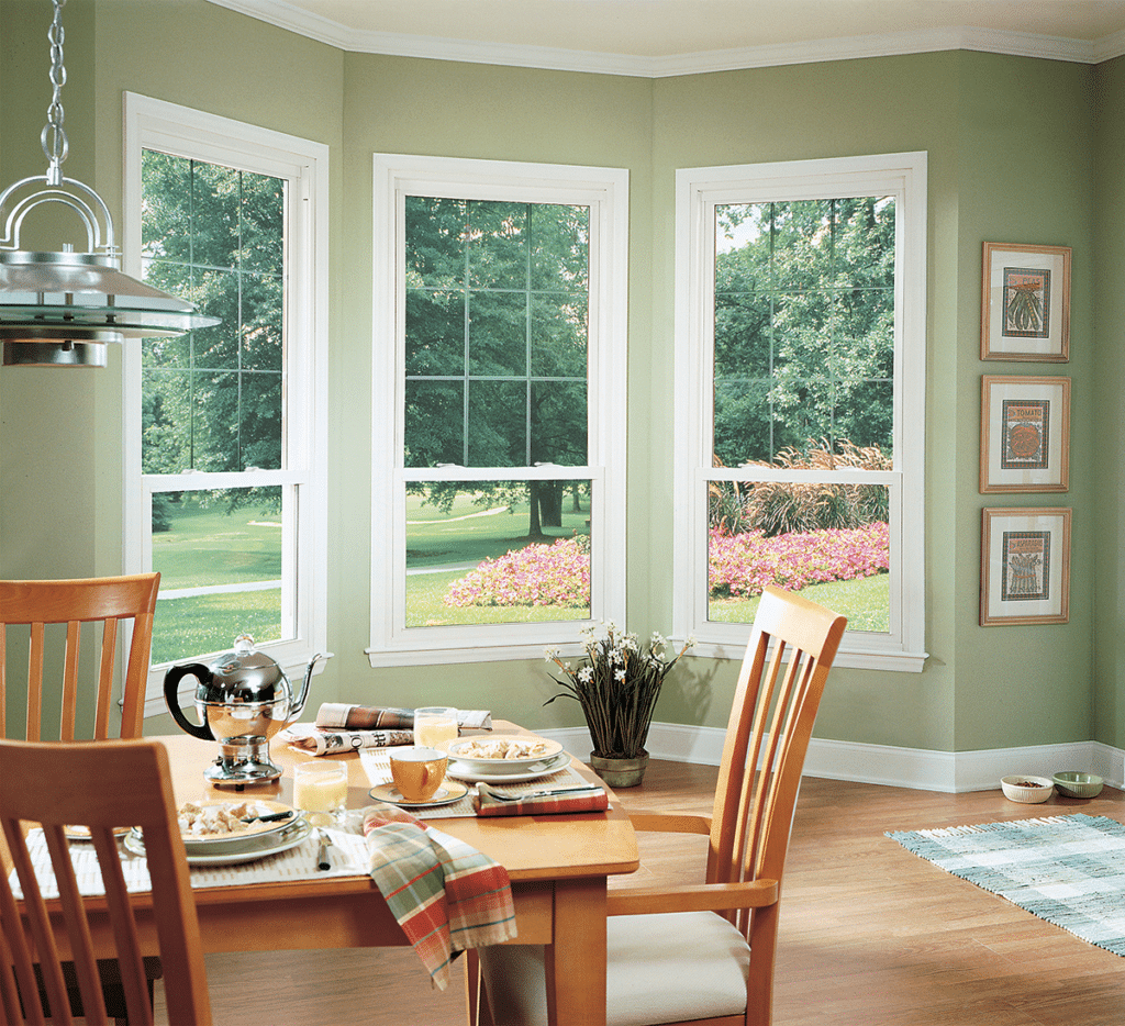 Here you can see Preservation double hung windows in an oriel style (meaning the top sash is larger than the bottom) with etched glass grids.